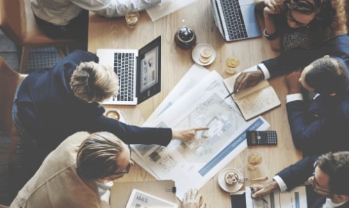 Colleagues collaborating around a desk