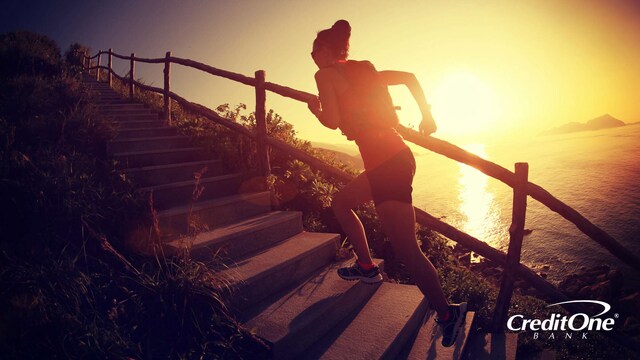 Woman making progress running up a set of stairs